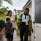 In Touch Pest Control technician checking a home exterior with a family during hurricane season
