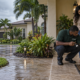 In Touch technician inspecting a South Florida home entryway after rain with a homeowner